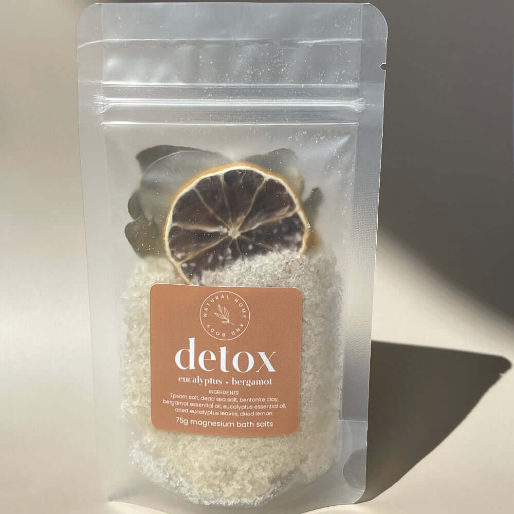 75g 'detox' magnesium bath salts on display on a coloured background with the sun as natural lighting.