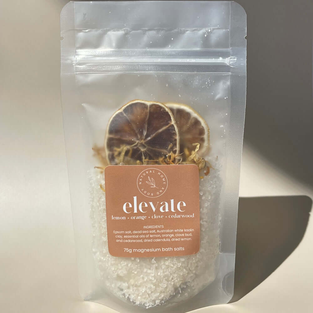 75g 'elevate' magnesium bath salts on display on a coloured background with the sun as natural lighting.