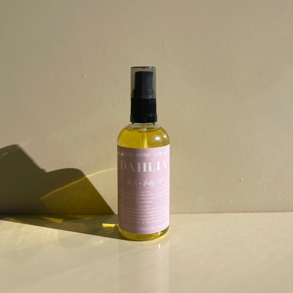 Body Oil with the sunlight as a reflection onto a beige background.