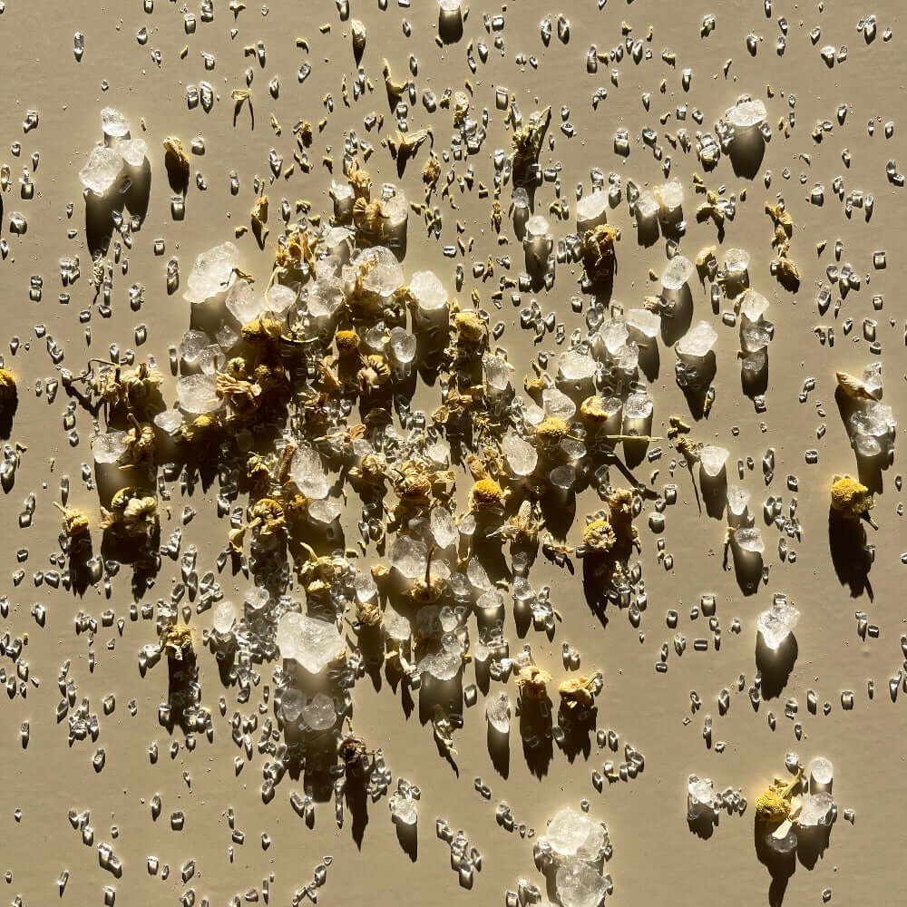 Nourish magnesium bath salts product on a surface background.