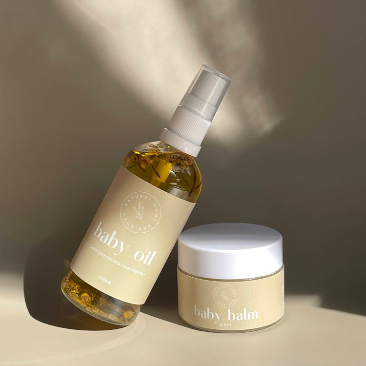 Baby oil bottle and balm jar on a neutral background