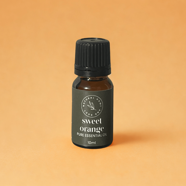 Bottle of sweet orange pure essential oil on a beige background