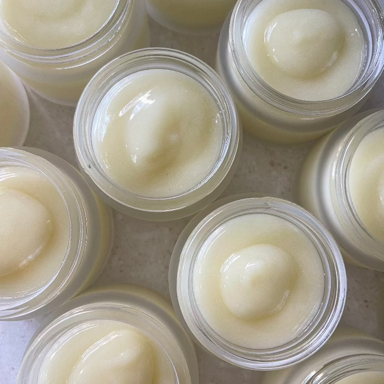 Jars of freshly made Baby Balm lined up together with lids off.