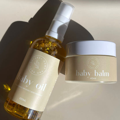 Baby oil bottle and baby balm jar on a neutral background