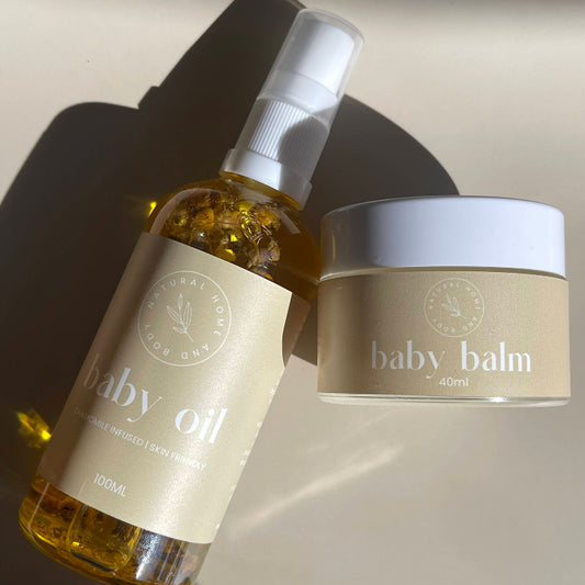 Baby oil bottle and baby balm jar on a neutral background