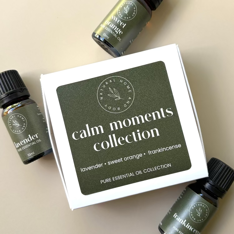 Calm Moments Collection' trio essential oil box, with essential oil bottles labelled 'lavender' 'sweet orange' and 'frankincense' next to the box. All with dark green product labels.
