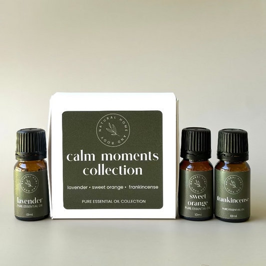'Calm Moments Collection' trio essential oil box, with essential oil bottles labelled 'lavender' 'sweet orange' and 'frankincense' next to the box. All with dark green product labels.