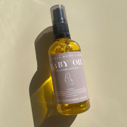 Baby Oil placed down on a beige background taking in the sunlight to create a reflective shadow.