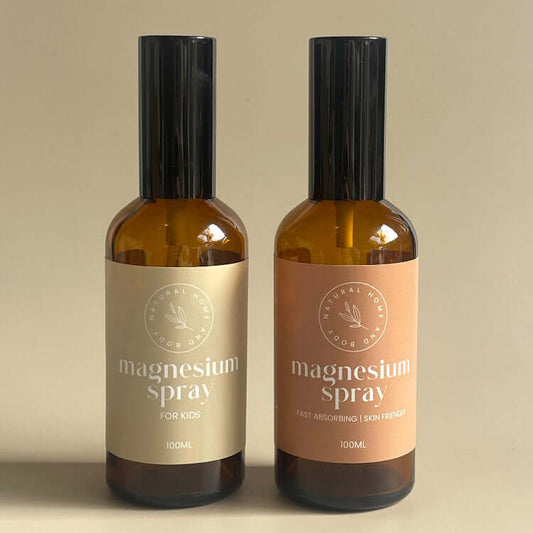 Two bottles of magnesium oil spray with labels on a beige background