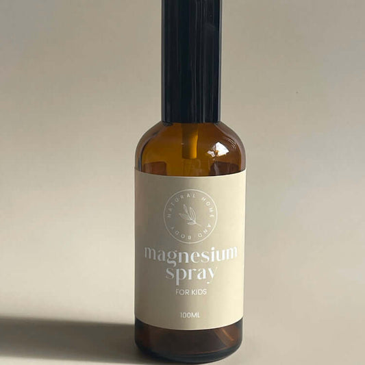 Kids formula magnesium oil spray displayed on a neutral coloured backdrop