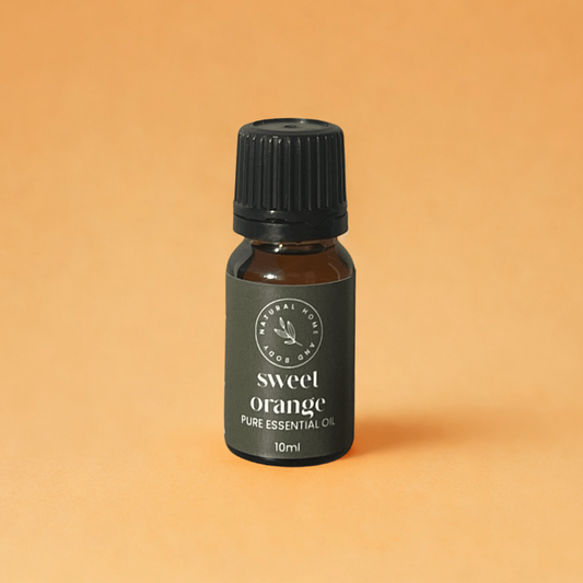 Bottle of sweet orange pure essential oil on a beige background